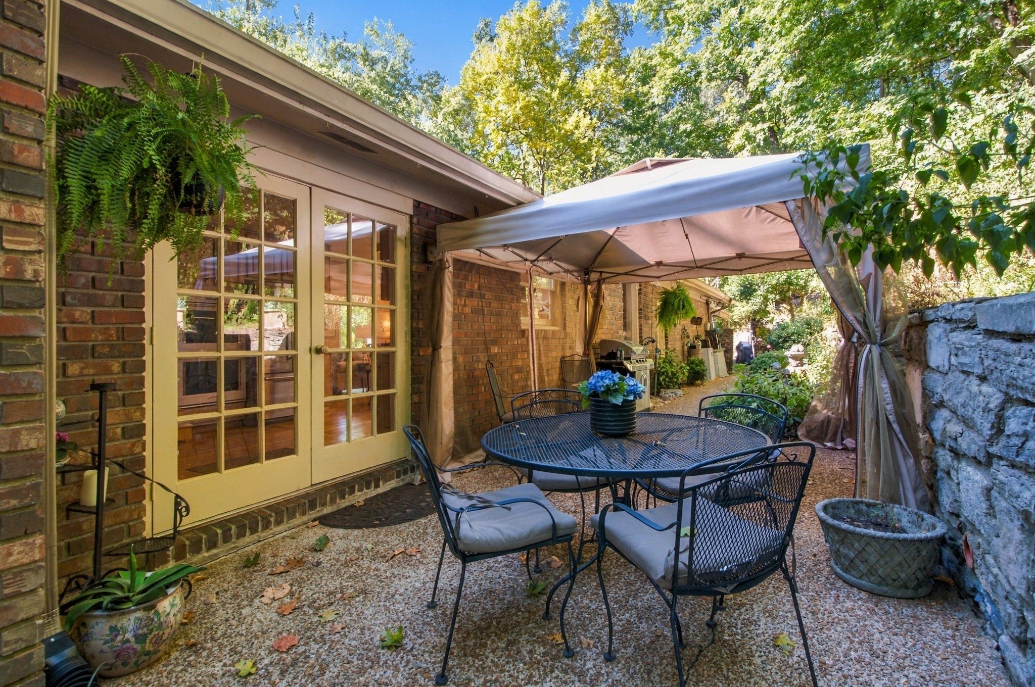 Patio behind the home with a wooded backdrop at 5312 Lancelot Road, Brentwood TN