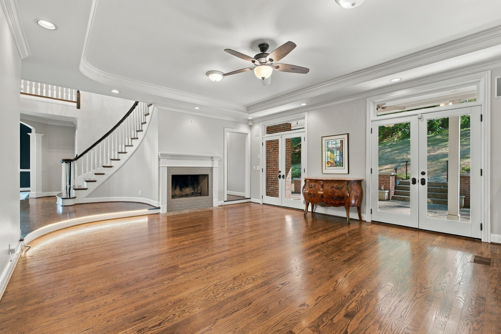 Family room with hardwood floors, a fireplace, and French doors at 710 Ashley Run, Brentwood TN