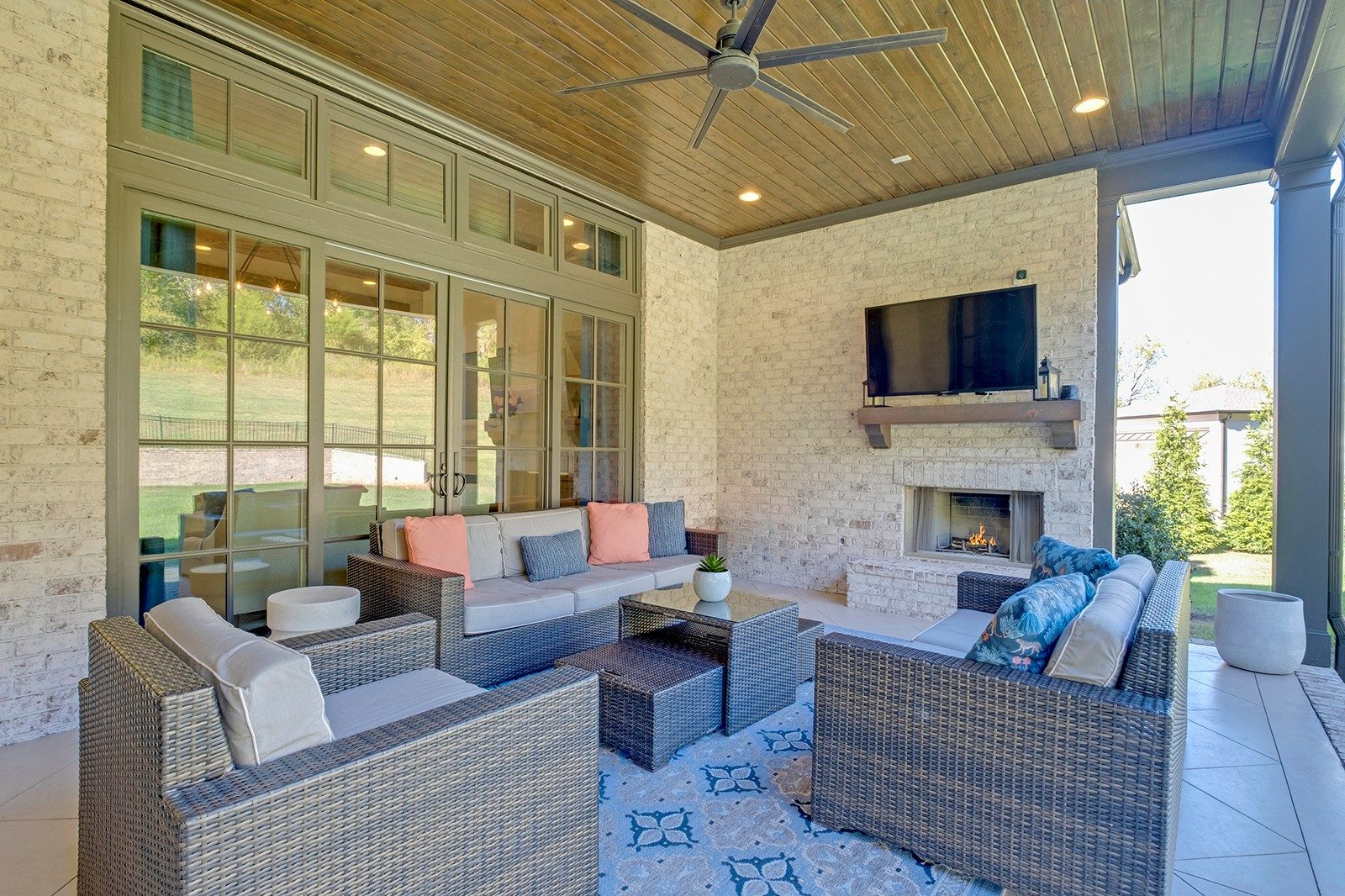 Covered patio with an outdoor fireplace at 9265 Berwyn Court, Brentwood TN