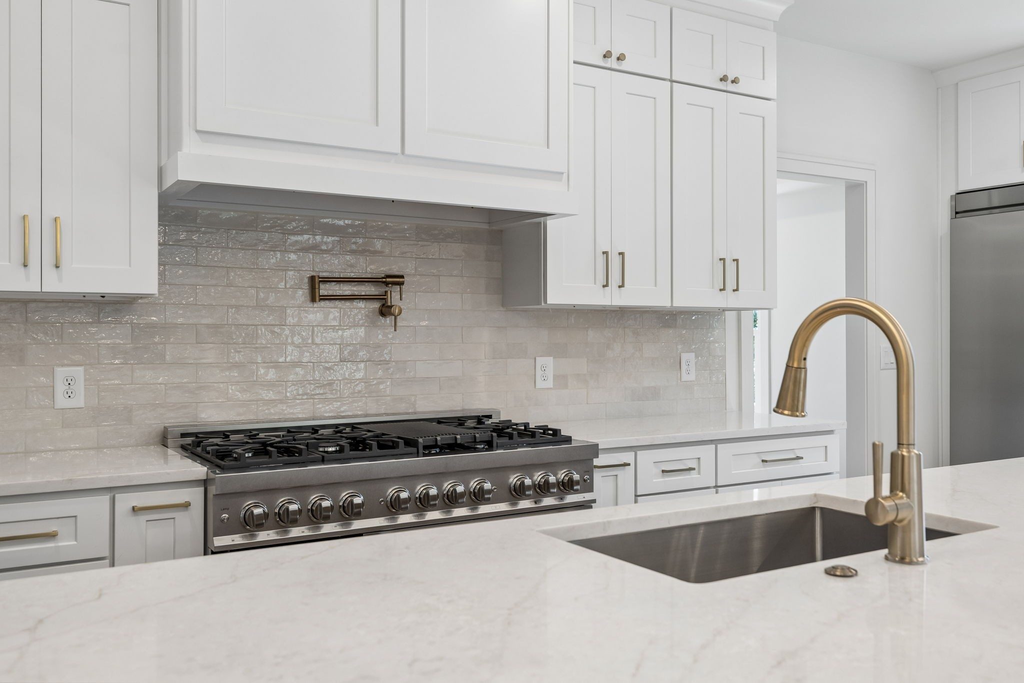 Renovated kitchen with a large island and a gas range at 9442 Foothills Drive, Brentwood TN