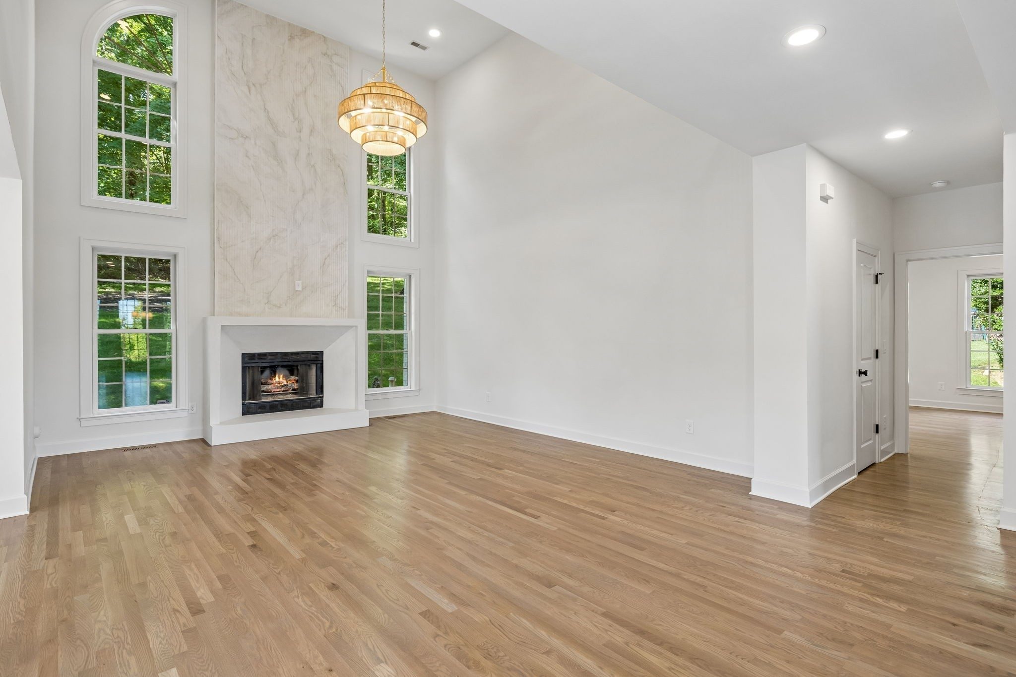 Living area with a custom fireplace and tall windows at 9442 Foothills Drive, Brentwood TN