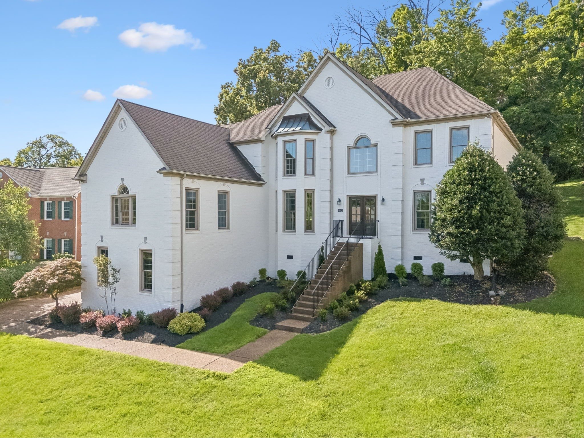 Second front exterior view with the lawn and driveway at 9442 Foothills Drive, Brentwood TN